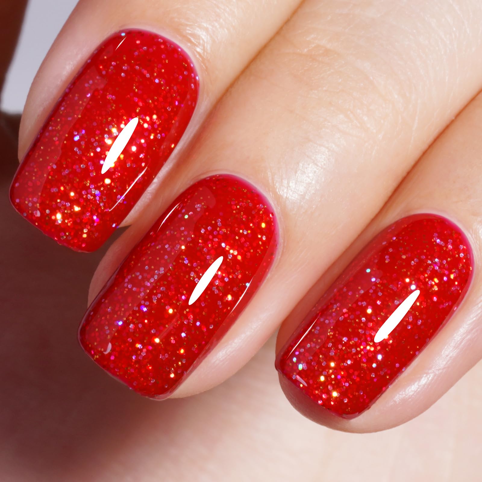 unha vermelha com glitter na ponta com brilho sutil